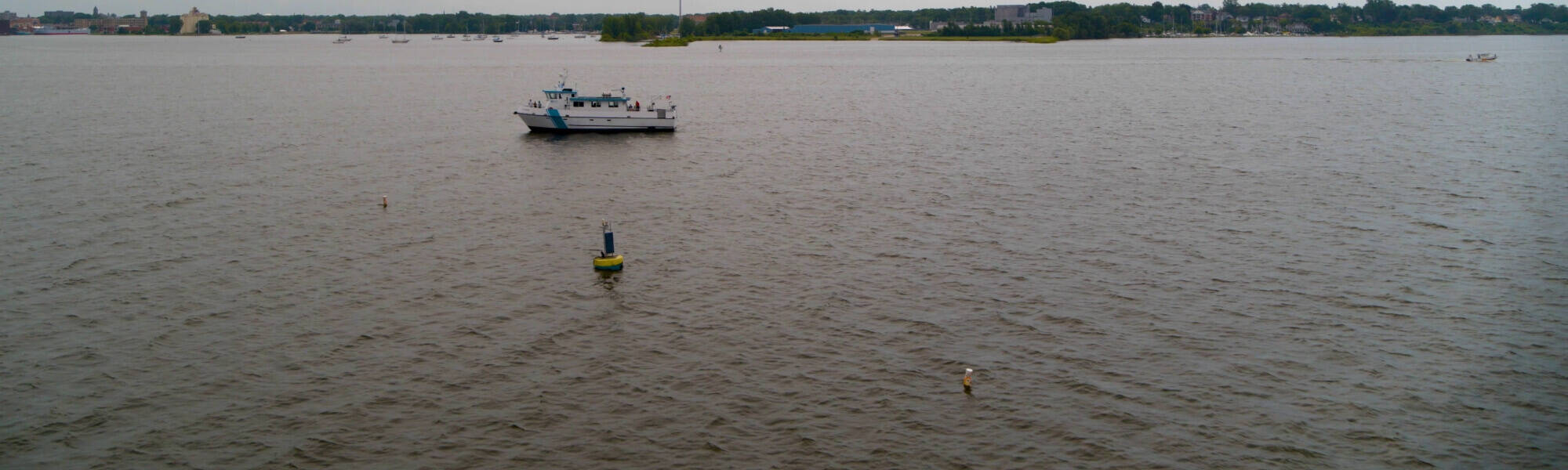 The W.G. Jackson research vessel travels past the Muskegon Lake Observatory buoy.